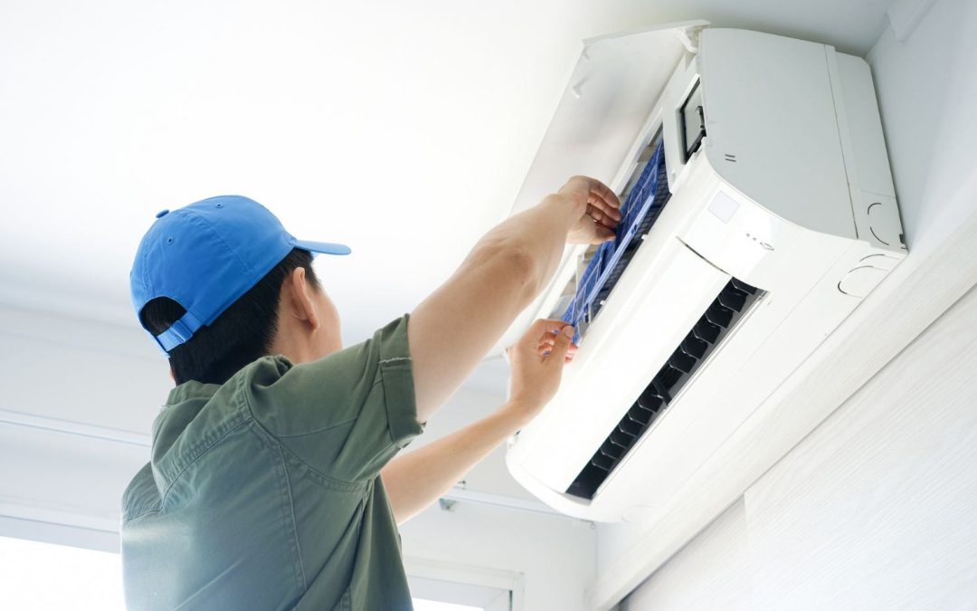 Air conditioning technician maintaining an indoor mini split system in Wheat Ridge, CO