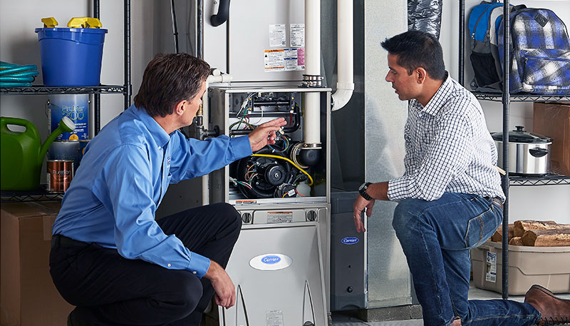 HVAC technician evaluating a furnace for repair or replacement in Wheat Ridge