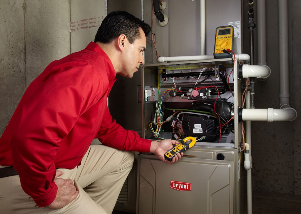 HVAC technician repairing an indoor furnace in Wheat Ridge