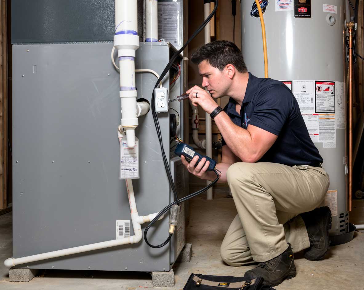 HVAC technician performing a furnace tune-up in Wheat Ridge