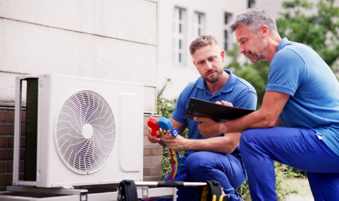 HVAC technicians installing an outdoor air conditioning unit in Wheat Ridge