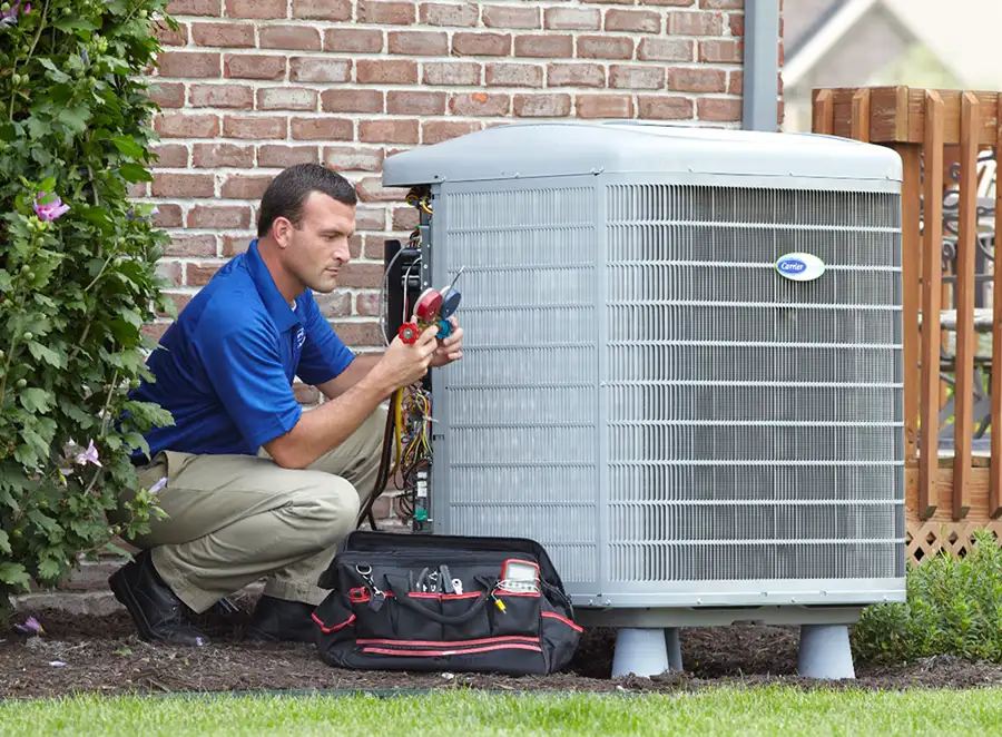 HVAC technician inspecting an outdoor air conditioning unit in Wheat Ridge